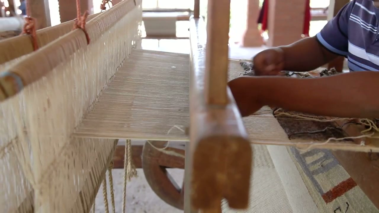 Large weaving loom producing cloth in a textile mill