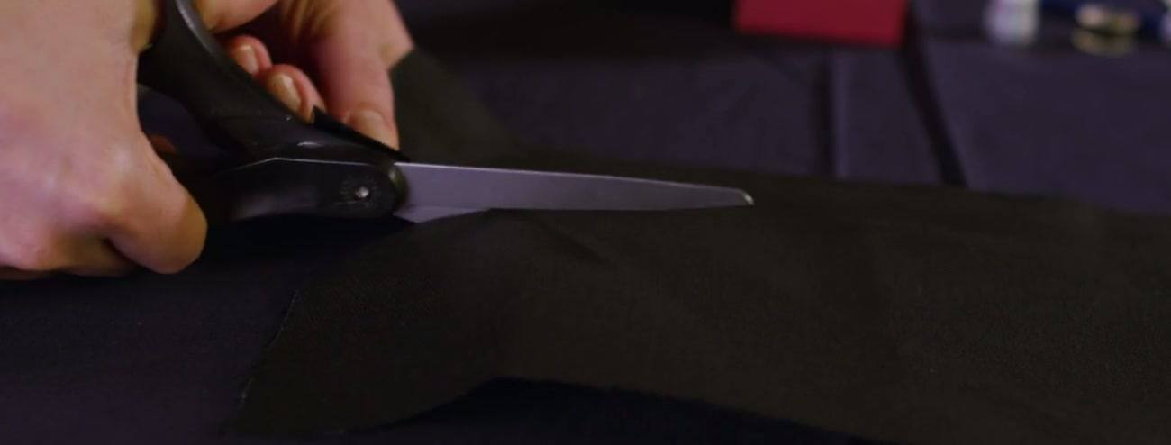 Industrial shears cutting fabric in a garment factory